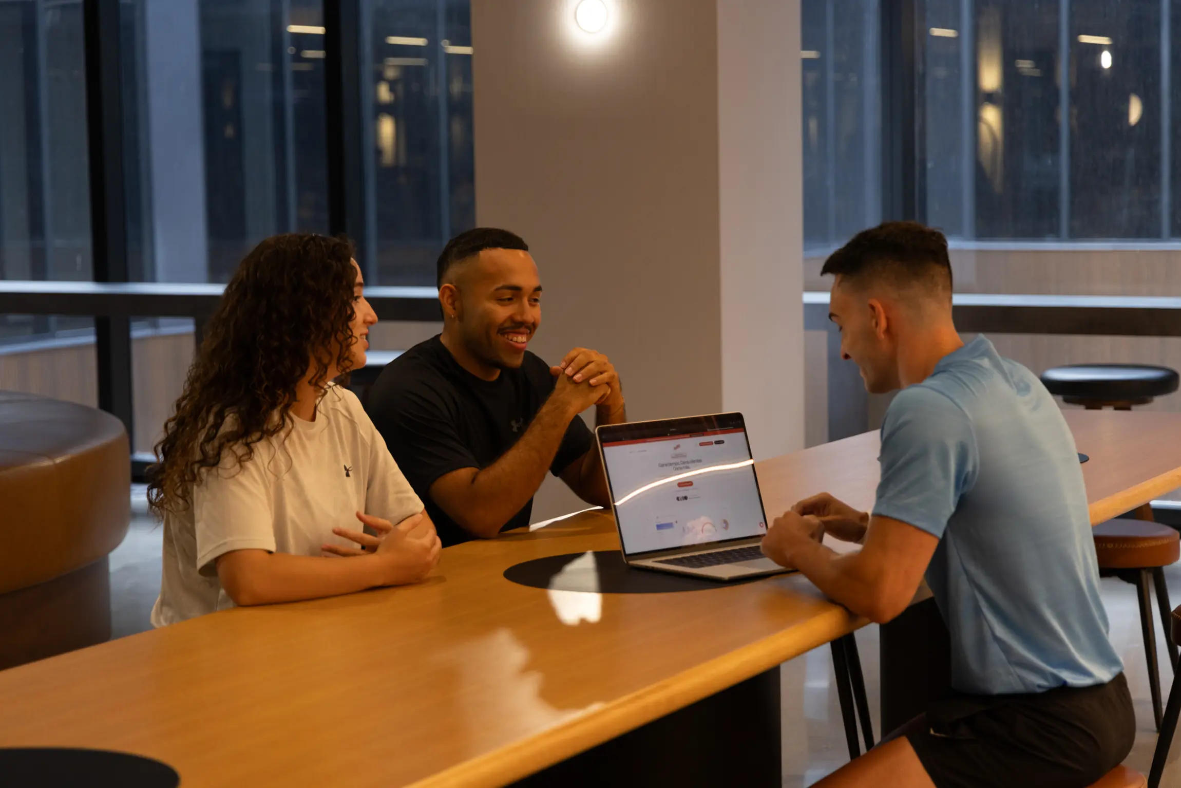 Nutrition coaching consultation — trainer reviewing a plan with two clients at a table