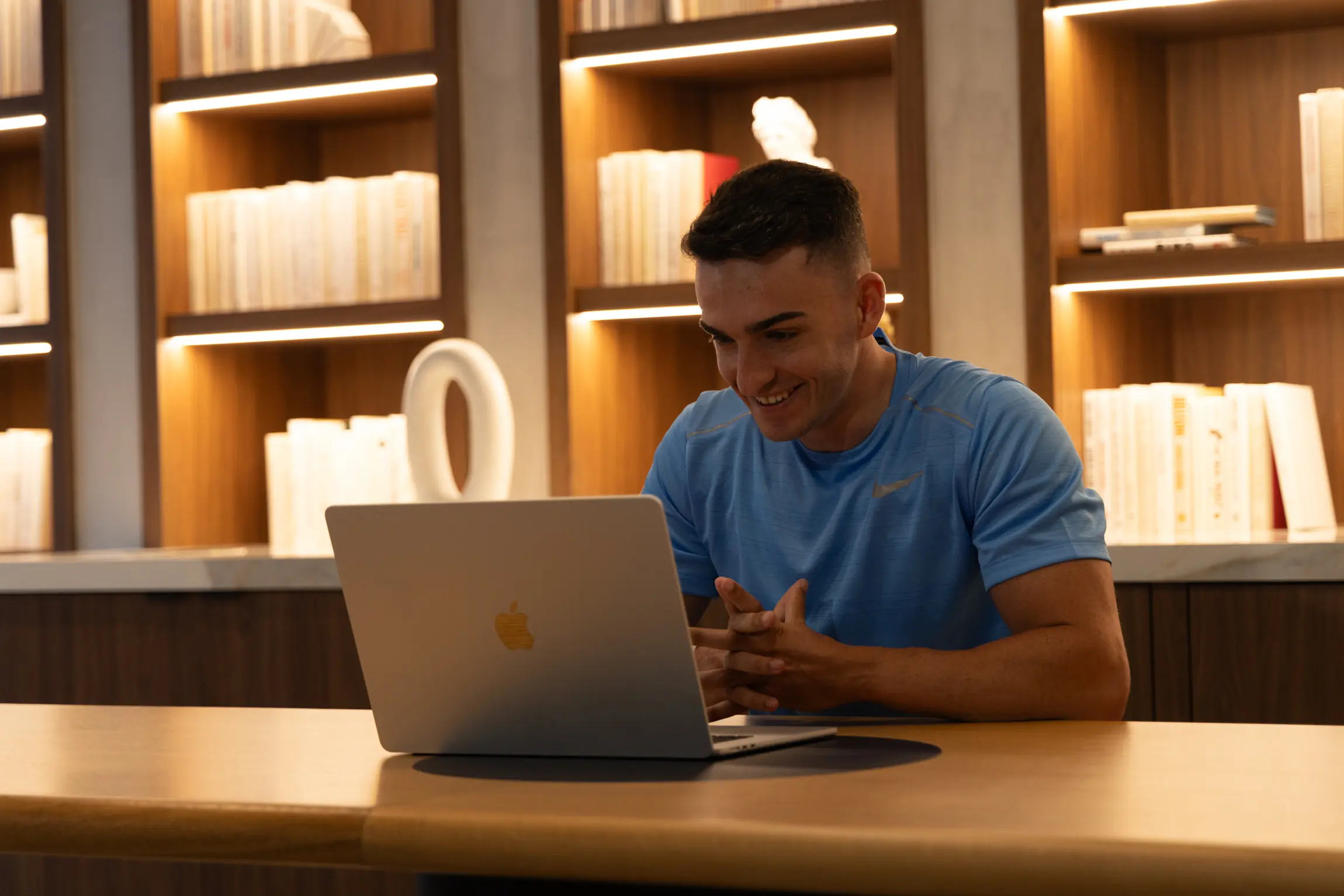 Trainer leading an online personal training session by video call from his laptop